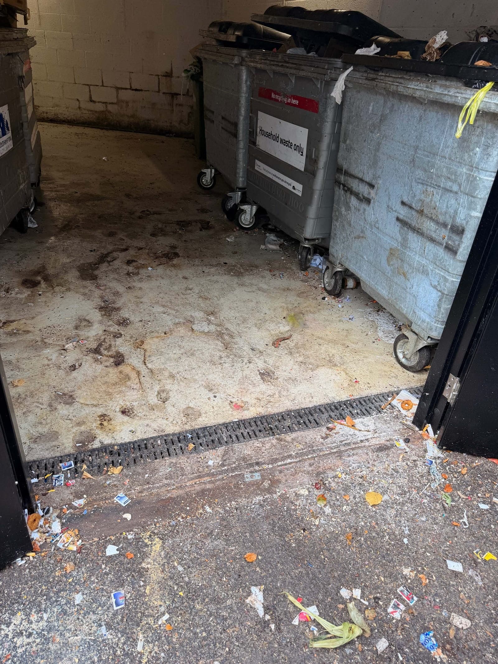 Bin store with household waste wheelie bins after floor clearance
