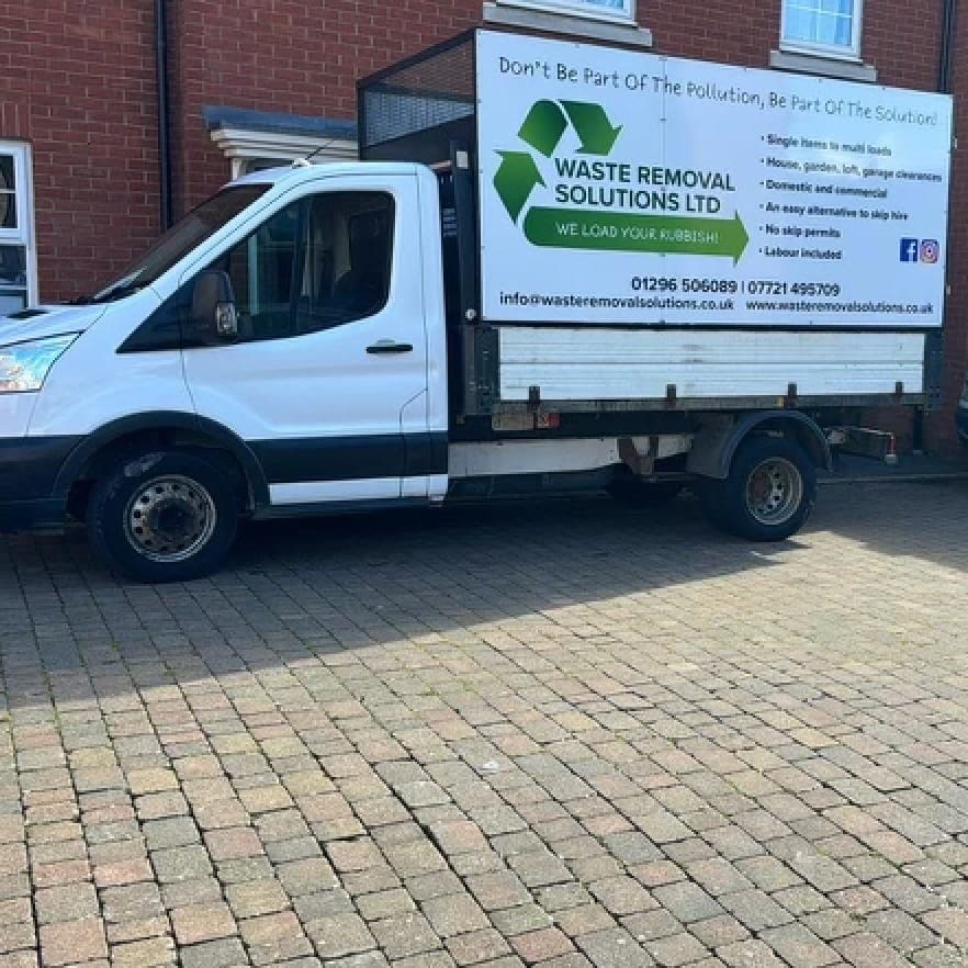 The branded Waste Removal Solutions Ltd tipper van, reading 'We load your rubbish' with contact details