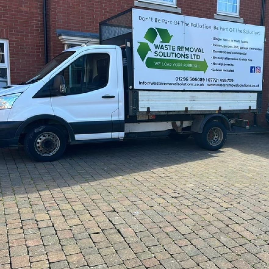 The branded Waste Removal Solutions Ltd tipper van, reading 'We load your rubbish' with contact details